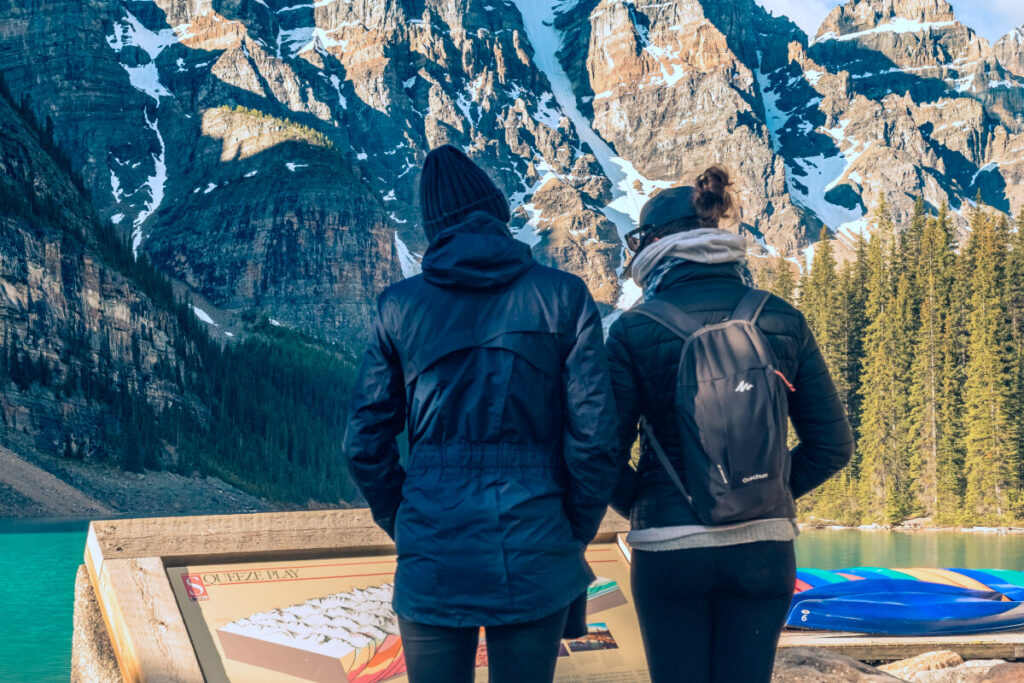 man-and-woman-standing-on-brown-wooden-dock-during-daytime
